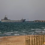Aid begins to enter Gaza through US-built dock, but officials say it is not enough